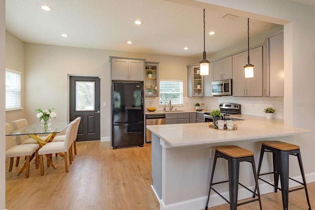 Dining room, Interior, Kitchen, Pendant Lights, Recessed Lighting, Stainless Steel Appliances, Wood Texture Flooring
