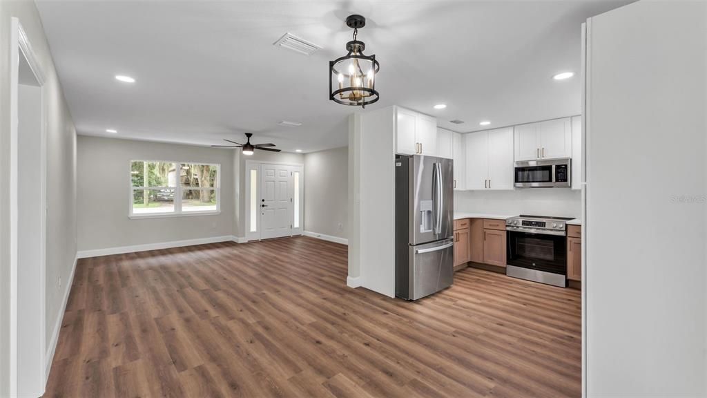 Empty room, Interior, Kitchen, Pendant Lights, Recessed Lighting, Stainless Steel Appliances, Wood Texture Flooring