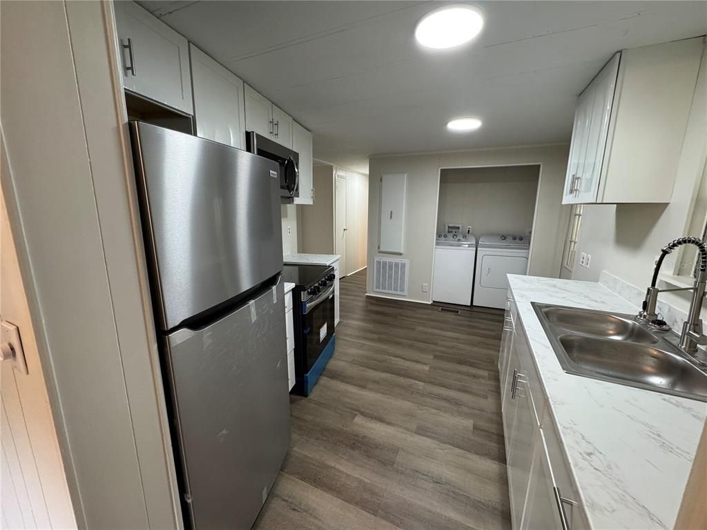 Interior, Kitchen, Recessed Lighting, Washer, Wood Texture Flooring