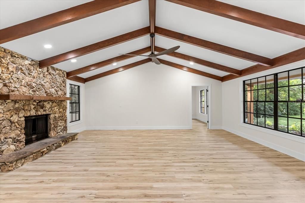 Empty room, Fireplace, Interior, Recessed Lighting, Stone Walls, Wooden Beams, Wood Texture Flooring