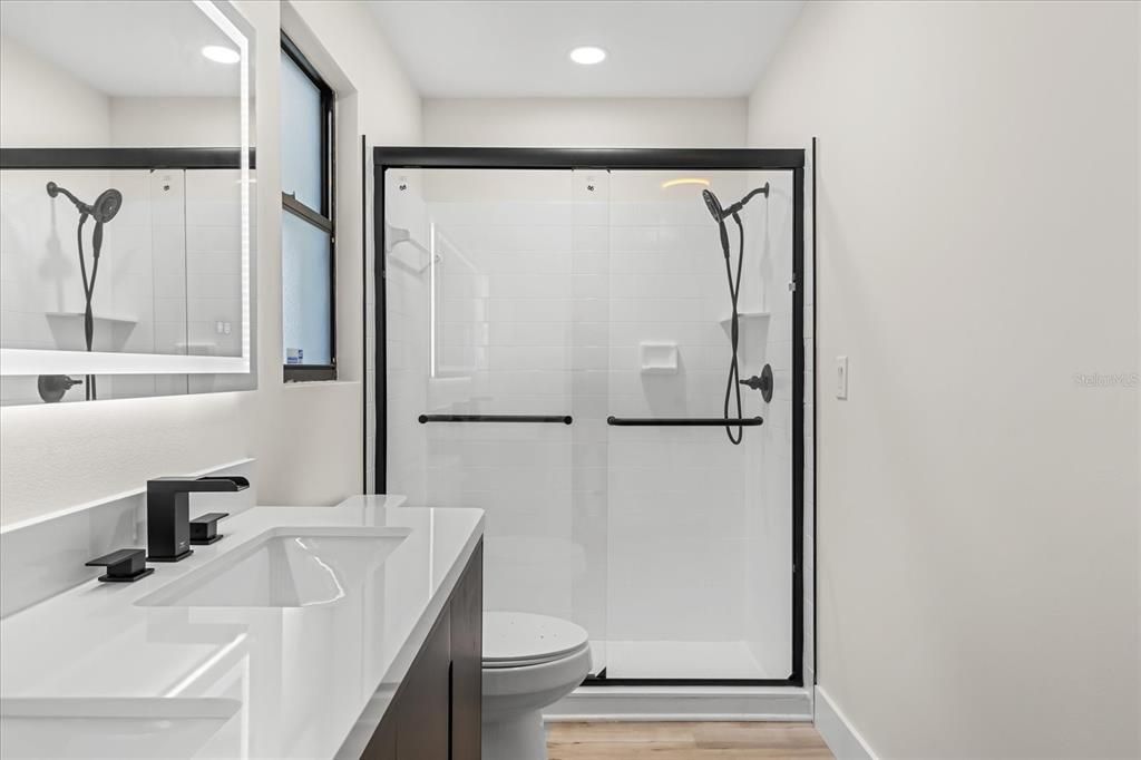 Bathroom, Dual Sink Vanities, Glass Shower, Interior, Recessed Lighting, Wood Texture Flooring