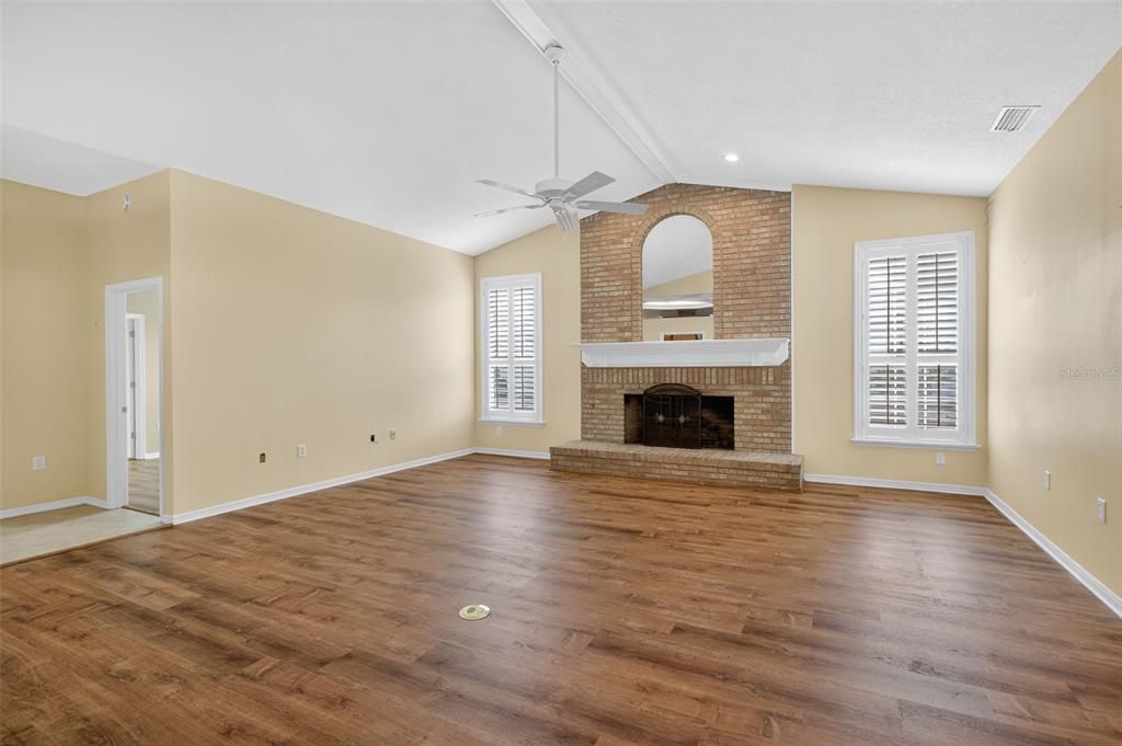 Empty room, Fireplace, Interior, Recessed Lighting, Stone Walls, Wood Texture Flooring
