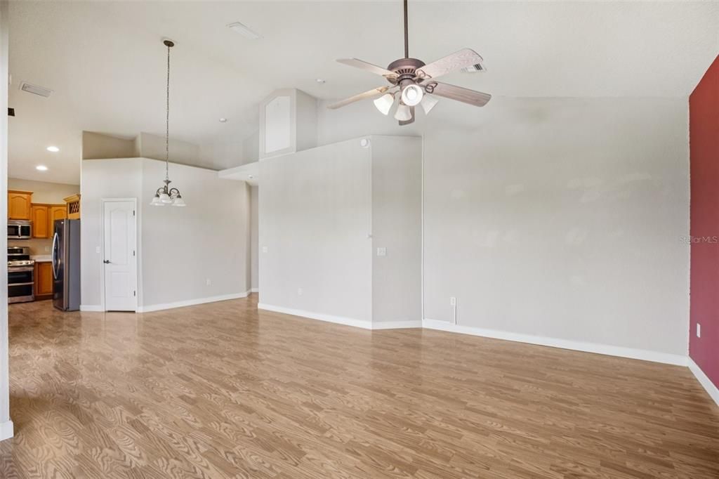 Empty room, Interior, Kitchen, Pendant Lights, Recessed Lighting, Stainless Steel Appliances, Wood Texture Flooring