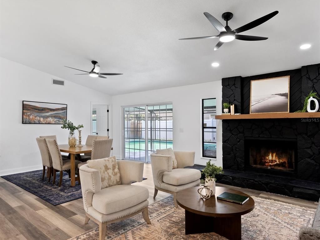 Dining room, Fireplace, Interior, Living room, Recessed Lighting, Wood Texture Flooring
