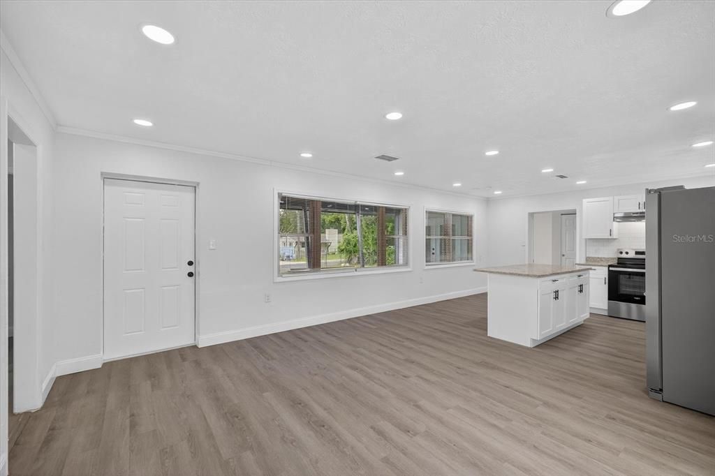 Empty room, Interior, Kitchen, Recessed Lighting, Stainless Steel Appliances, Wood Texture Flooring