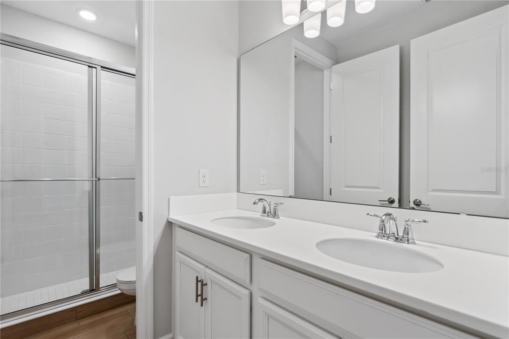Bathroom, Dual Sink Vanities, Glass Shower, Interior, Recessed Lighting, Wood Texture Flooring