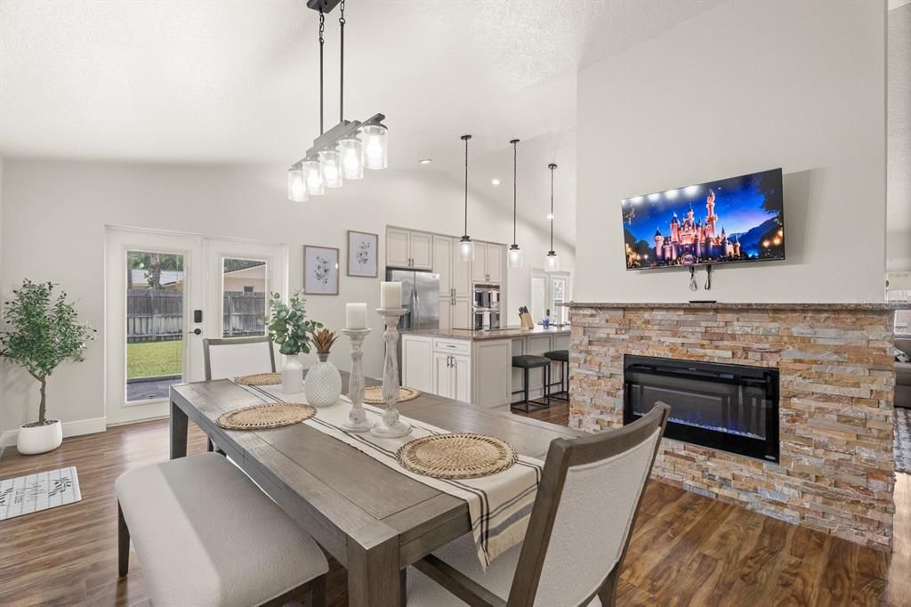 Dining room, Fireplace, Interior, Kitchen, Pendant Lights, Recessed Lighting, Stainless Steel Appliances, Wood Texture Flooring