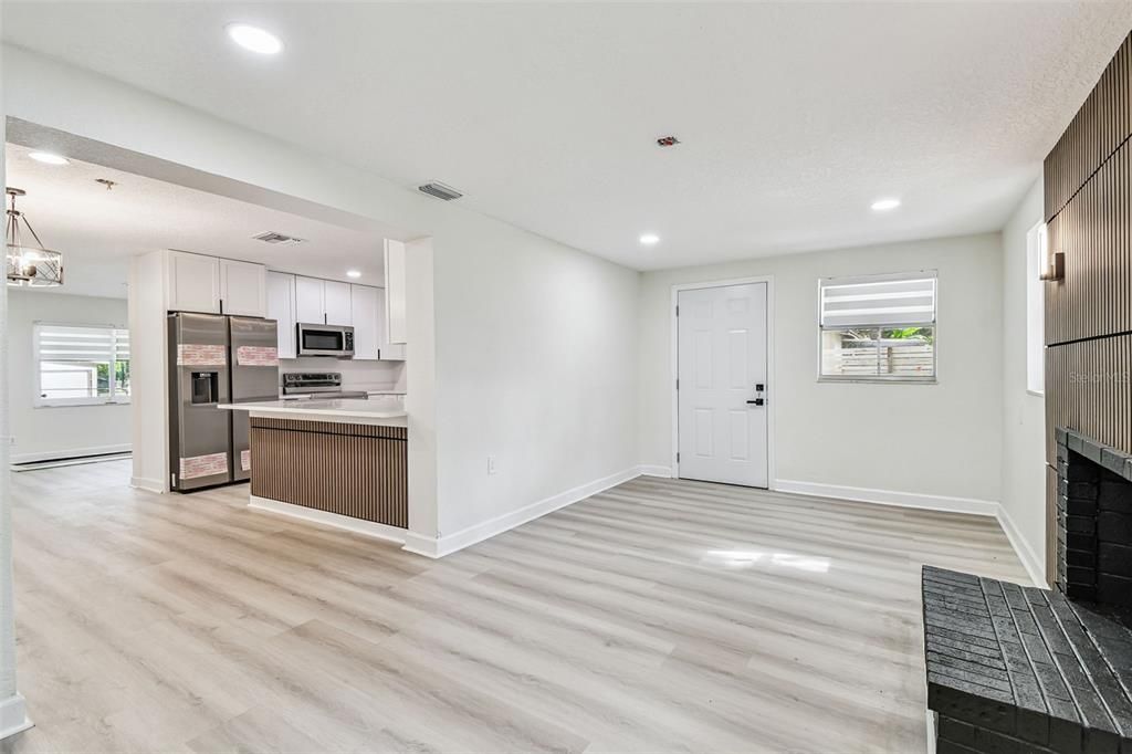 Chandelier, Fireplace, Interior, Kitchen, Pendant Lights, Recessed Lighting, Stainless Steel Appliances, Wood Texture Flooring