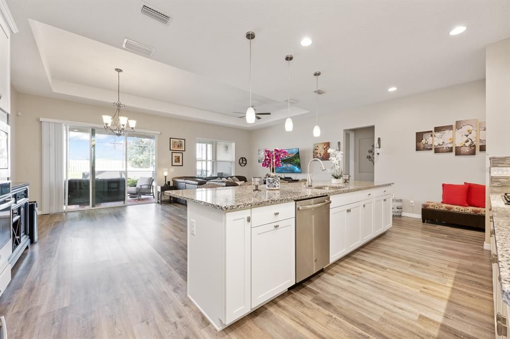 Chandelier, Interior, Kitchen, Living room, Pendant Lights, Recessed Lighting, Stainless Steel Appliances, Wood Texture Flooring