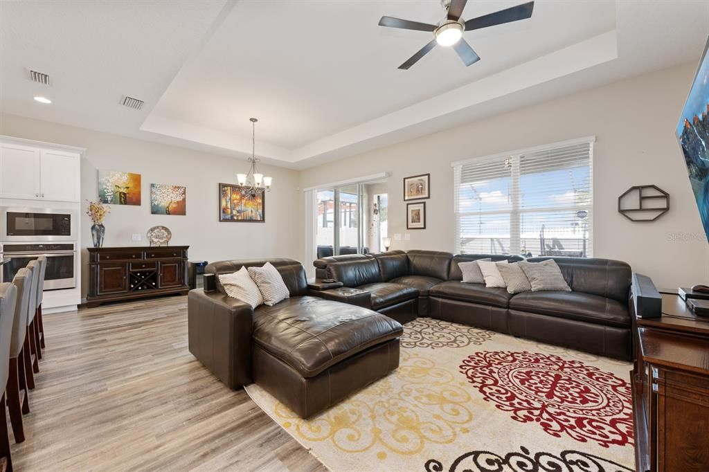 Chandelier, Interior, Kitchen, Living room, Recessed Lighting, Stainless Steel Appliances, Wood Texture Flooring