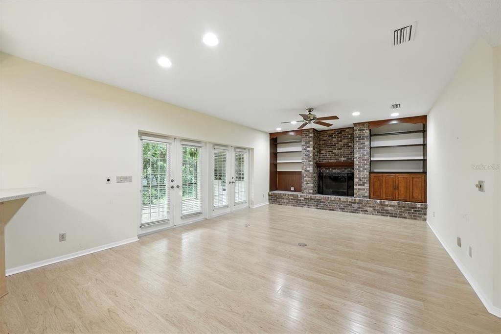 Empty room, Fireplace, Interior, Recessed Lighting, Stone Walls, Wood Texture Flooring