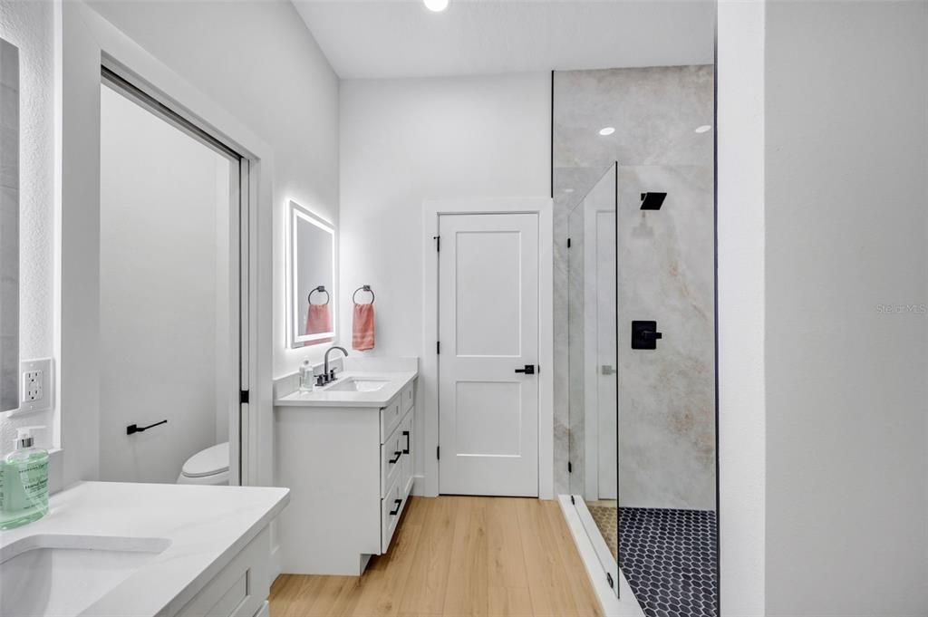 Bathroom, Dual Sink Vanities, Glass Shower, Interior, Recessed Lighting, Wood Texture Flooring