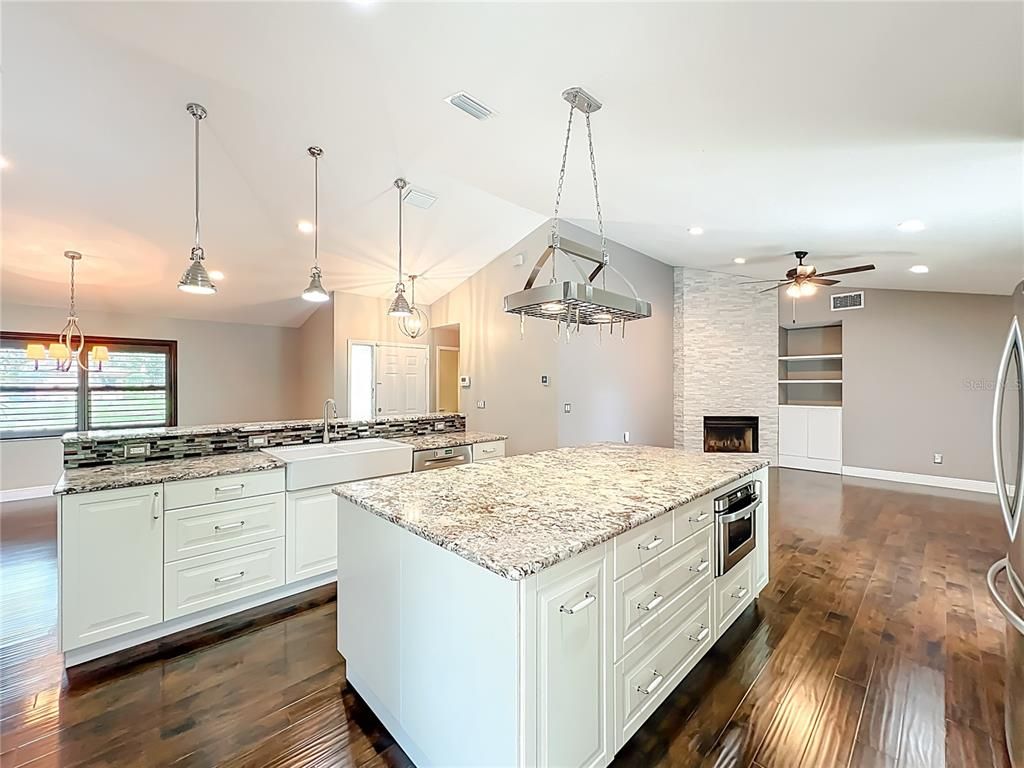 Fireplace, Interior, Kitchen, Pendant Lights, Recessed Lighting, Stainless Steel Appliances, Wood Texture Flooring