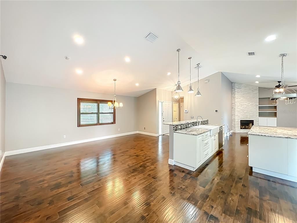 Empty room, Fireplace, Interior, Kitchen, Pendant Lights, Recessed Lighting, Wood Texture Flooring