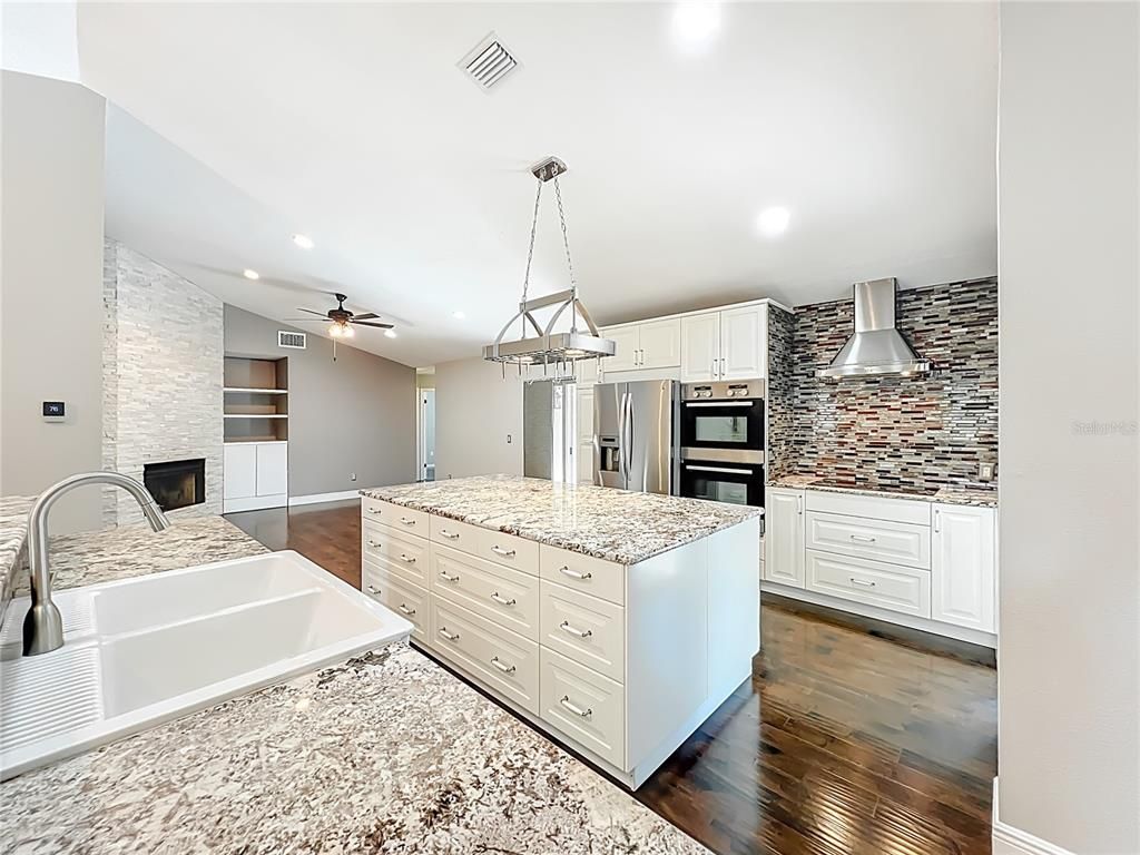 Fireplace, Interior, Kitchen, Pendant Lights, Recessed Lighting, Stainless Steel Appliances, Wood Texture Flooring