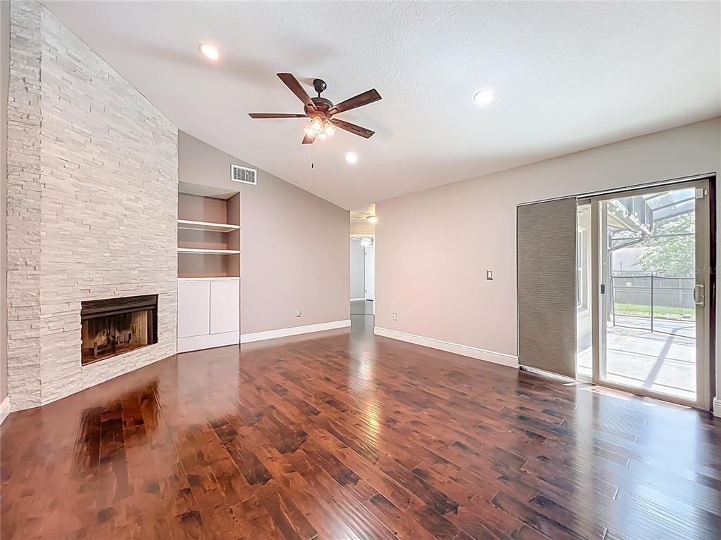 Empty room, Fireplace, Interior, Recessed Lighting, Stone Walls, Wood Texture Flooring
