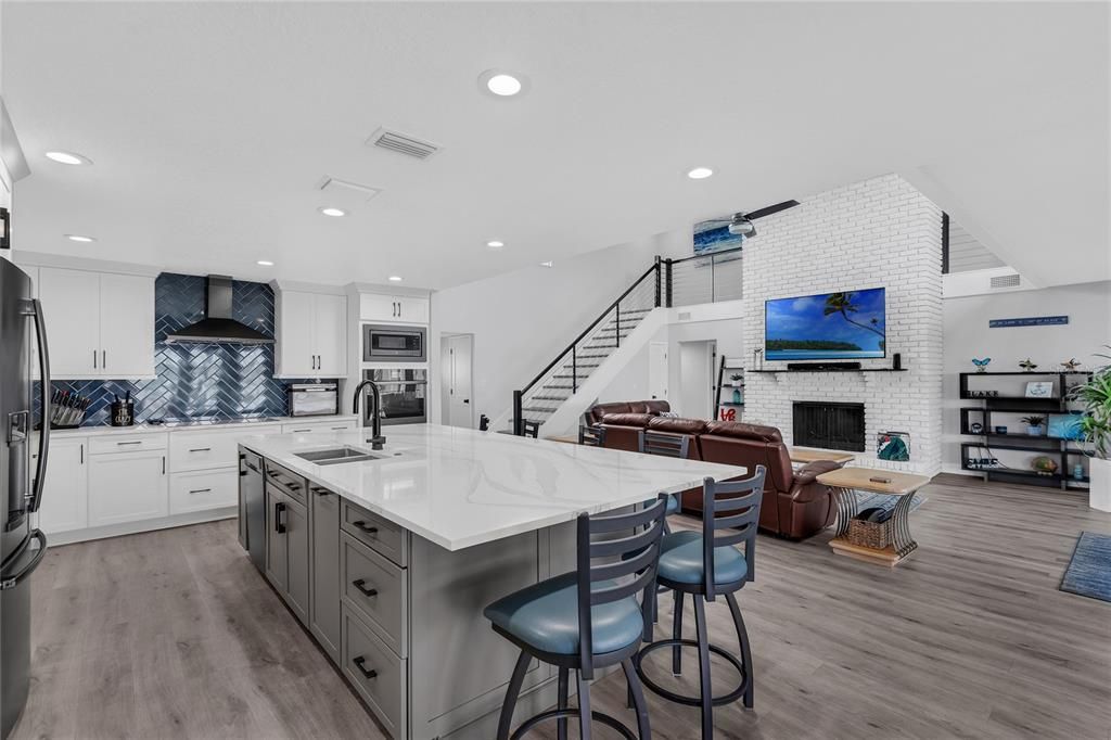 Fireplace, Interior, Kitchen, Living room, Recessed Lighting, Stainless Steel Appliances, Stone Walls, Wood Texture Flooring