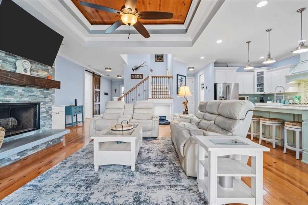 Fireplace, Interior, Kitchen, Living room, Pendant Lights, Recessed Lighting, Stainless Steel Appliances, Stone Walls, Wood Texture Flooring