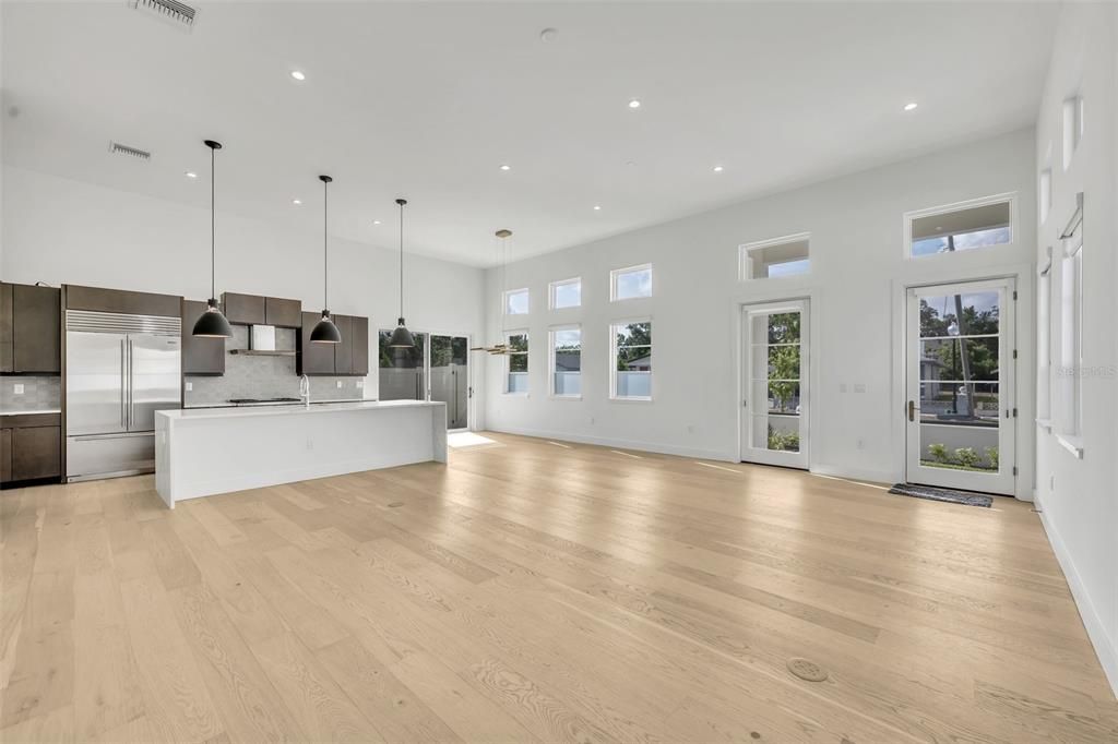 Empty room, Interior, Kitchen, Pendant Lights, Recessed Lighting, Stainless Steel Appliances, Wood Texture Flooring