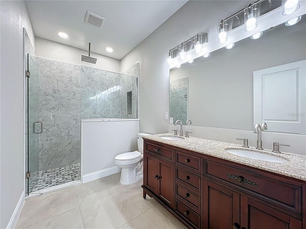 Bathroom, Dual Sink Vanities, Glass Shower, Interior, Marble, Marble Walls, Recessed Lighting