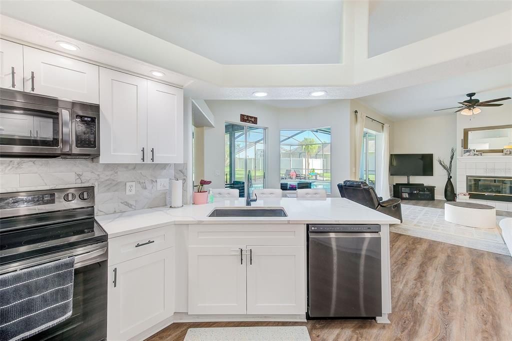 Fireplace, Interior, Kitchen, Living room, Recessed Lighting, Stainless Steel Appliances, Wood Texture Flooring