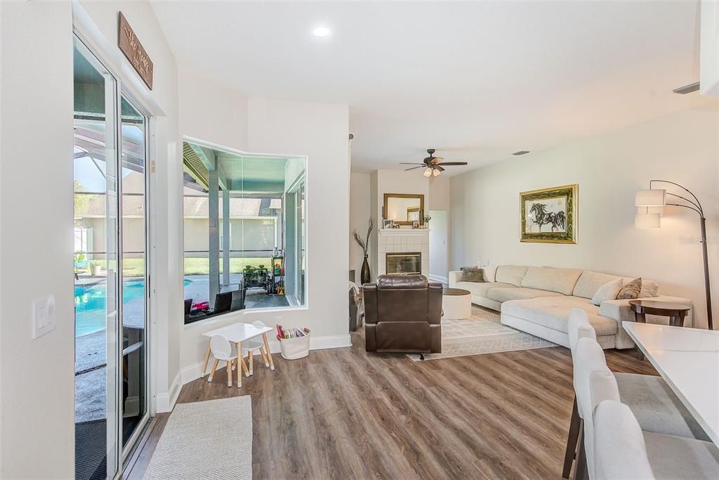 Dining room, Fireplace, Interior, Living room, Recessed Lighting, Wood Texture Flooring