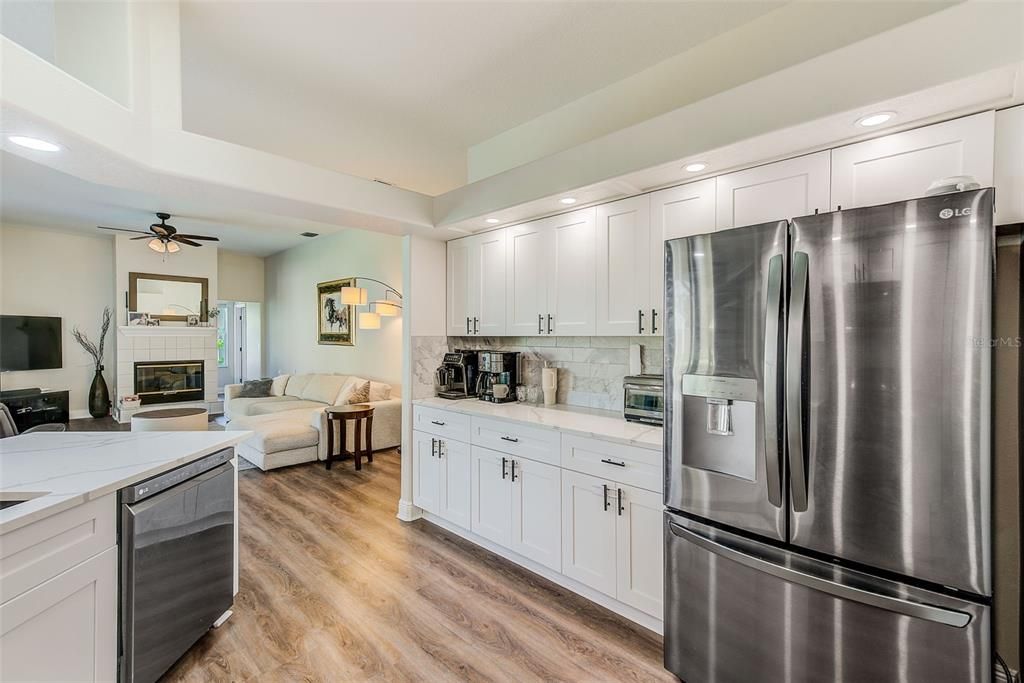 Fireplace, Interior, Kitchen, Living room, Recessed Lighting, Stainless Steel Appliances, Wood Texture Flooring