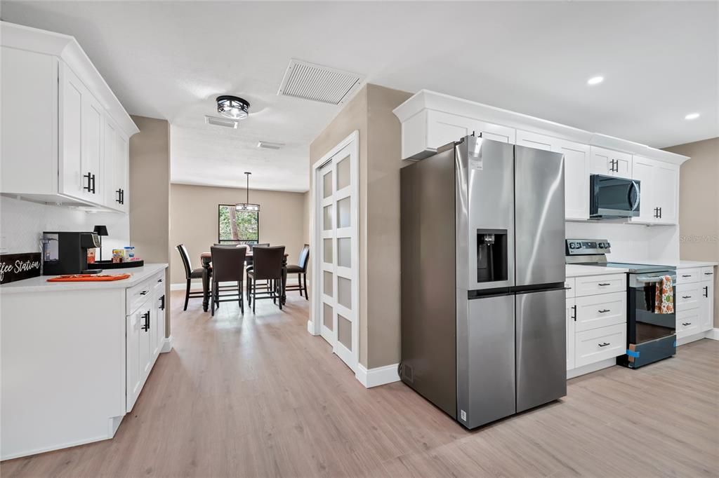 Dining room, Interior, Kitchen, Pendant Lights, Recessed Lighting, Stainless Steel Appliances, Wood Texture Flooring