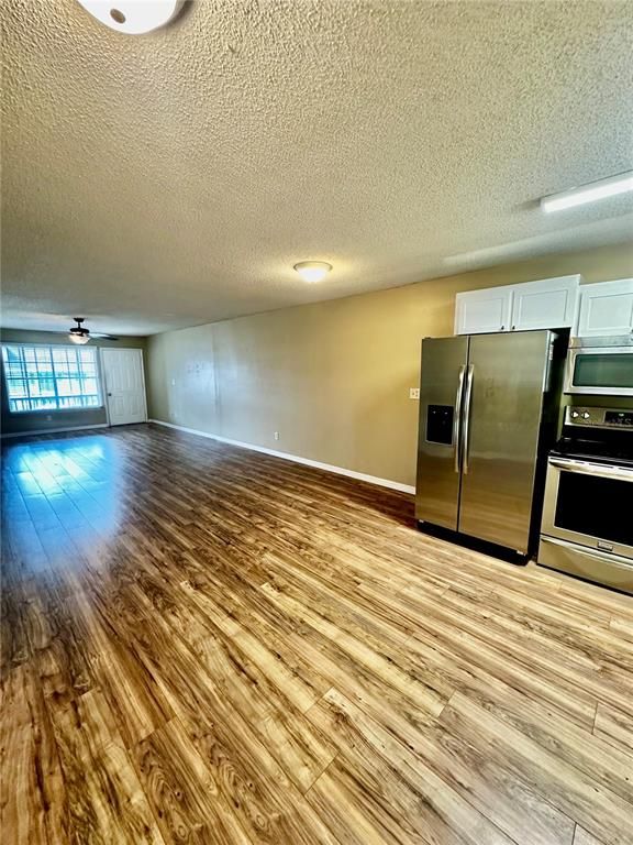 Empty room, Interior, Kitchen, Stainless Steel Appliances, Wood Texture Flooring