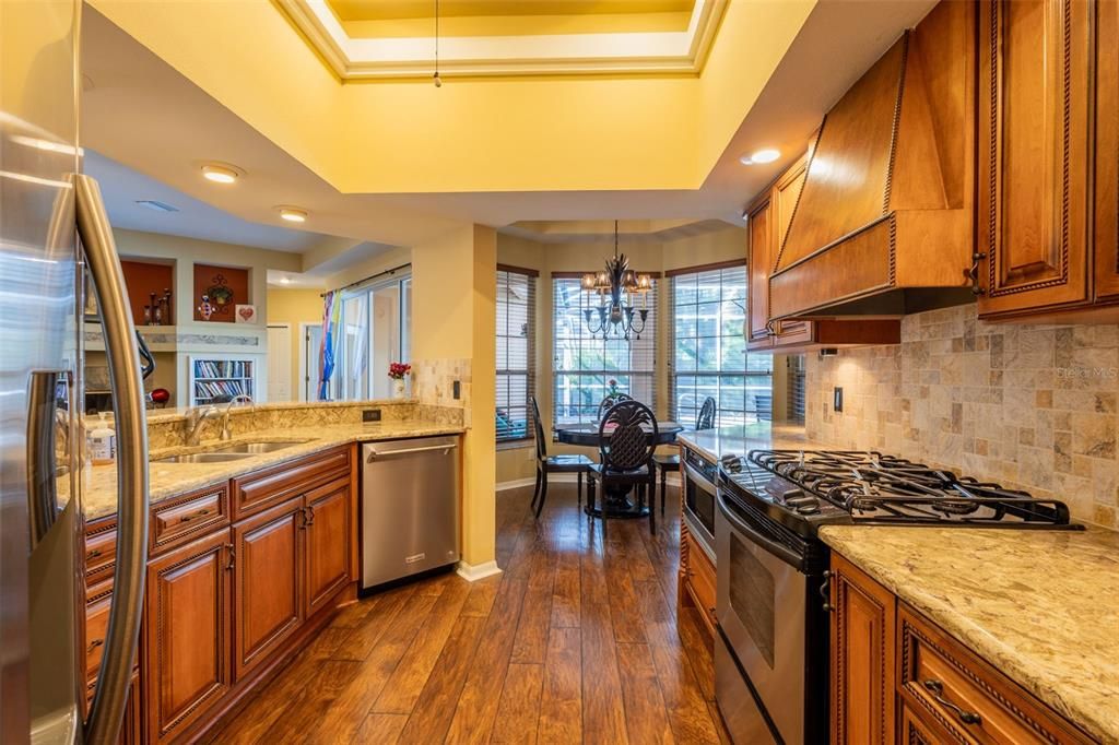 Chandelier, Dining room, Interior, Kitchen, Recessed Lighting, Stainless Steel Appliances, Wood Texture Flooring