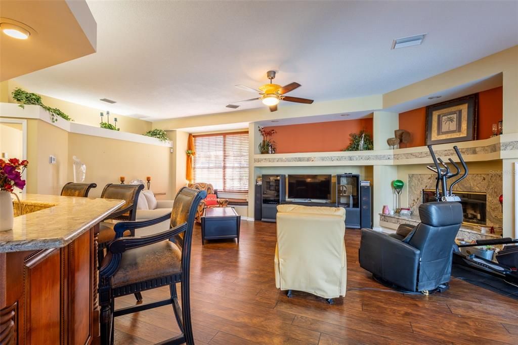 Dining room, Fireplace, Interior, Living room, Recessed Lighting, Wood Texture Flooring