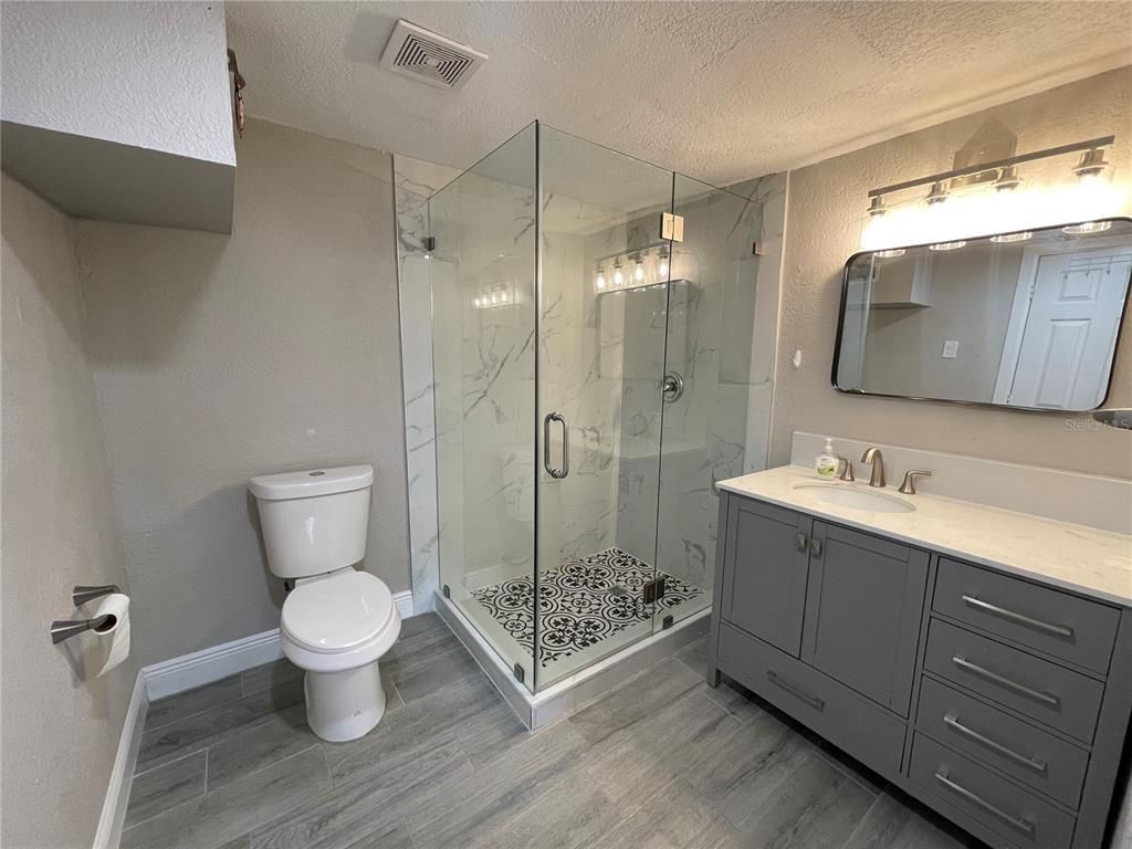 Bathroom, Glass Shower, Interior, Marble Walls, Wood Texture Flooring