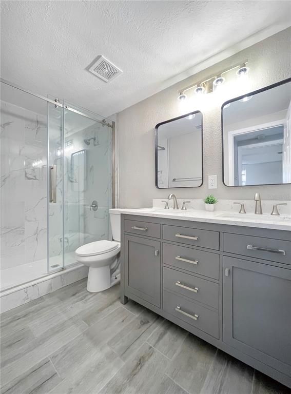 Bathroom, Dual Sink Vanities, Glass Shower, Interior, Marble Walls, Wood Texture Flooring