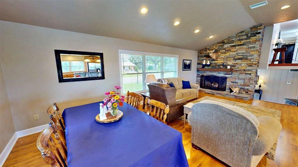 Dining room, Fireplace, Interior, Living room, Recessed Lighting, Stone Walls, Wood Texture Flooring
