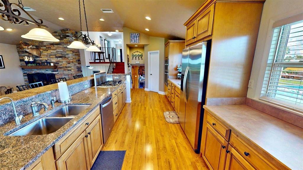 Interior, Kitchen, Pendant Lights, Recessed Lighting, Stainless Steel Appliances, Stone Walls, Wood Texture Flooring