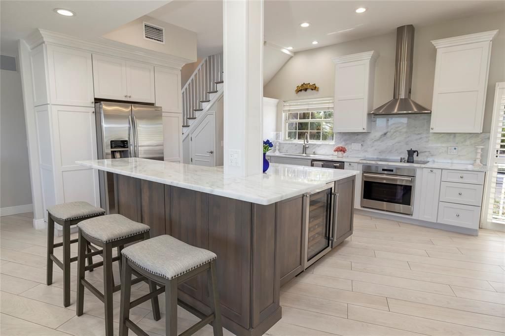 Interior, Kitchen, Marble Walls, Recessed Lighting, Stainless Steel Appliances, Wood Texture Flooring