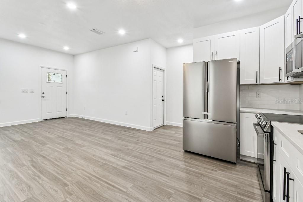 Interior, Kitchen, Recessed Lighting, Washer, Wood Texture Flooring
