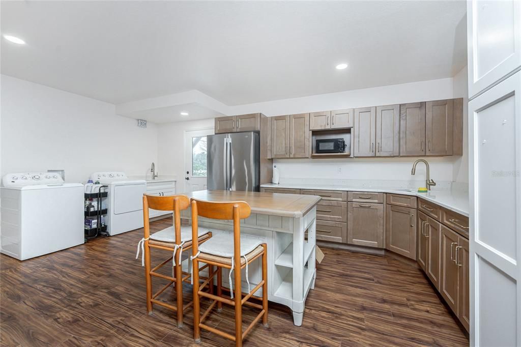 Interior, Kitchen, Recessed Lighting, Washer, Wood Texture Flooring