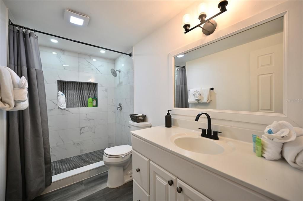 Bathroom, Glass Shower, Interior, Marble Walls, Recessed Lighting, Wood Texture Flooring