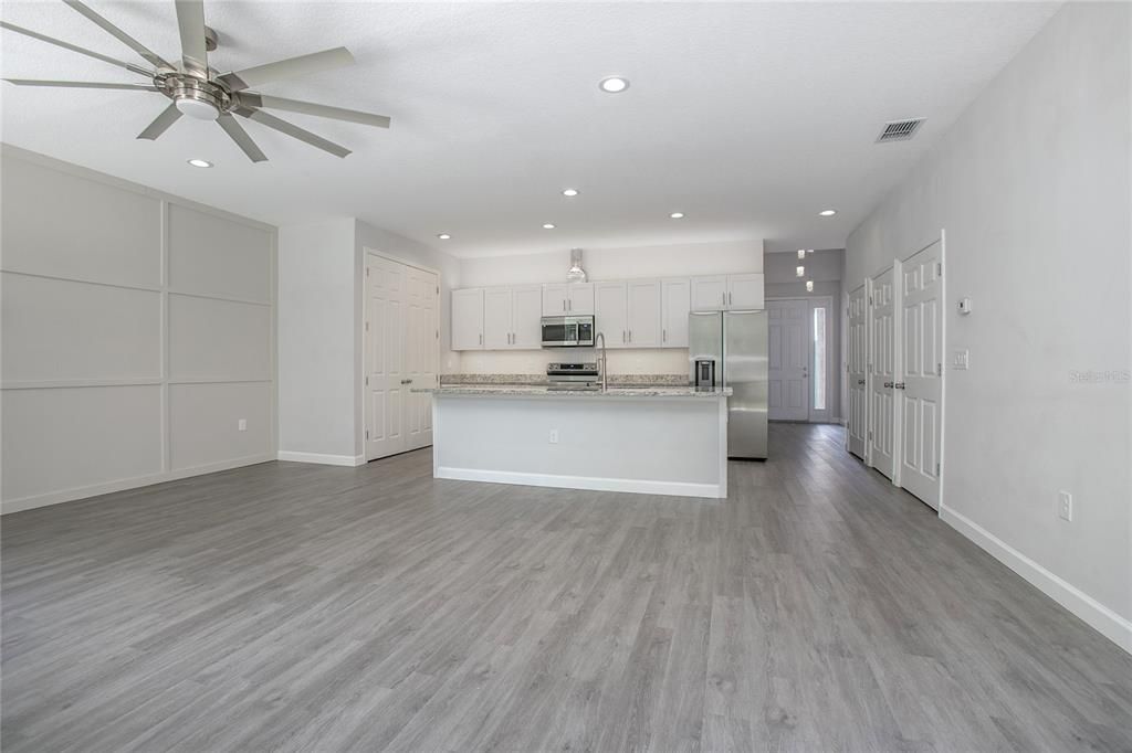 Empty room, Interior, Kitchen, Recessed Lighting, Stainless Steel Appliances, Wood Texture Flooring