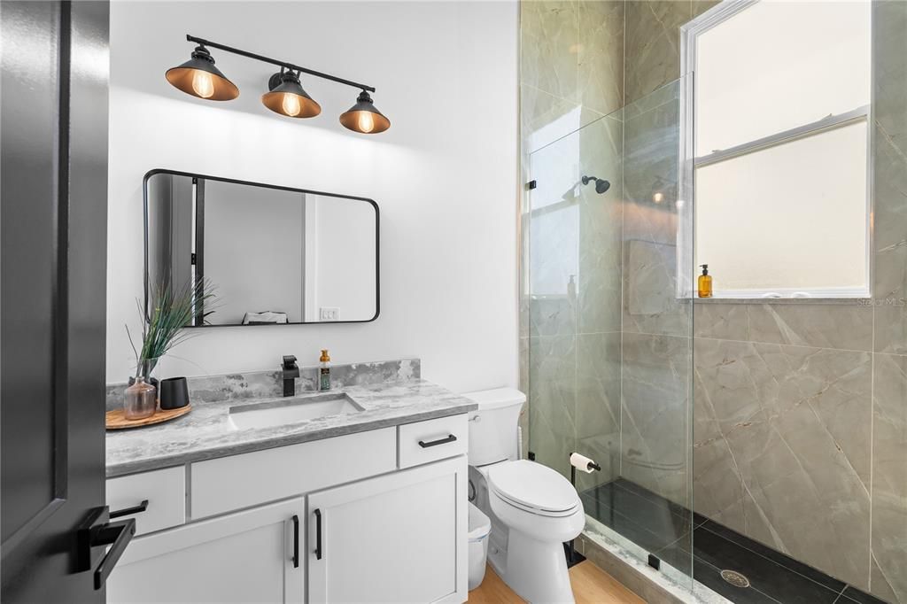 Bathroom, Glass Shower, Interior, Marble Walls, Wood Texture Flooring