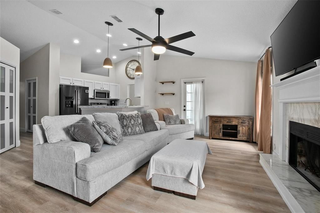 Fireplace, Interior, Kitchen, Living room, Pendant Lights, Recessed Lighting, Stainless Steel Appliances, Wood Texture Flooring