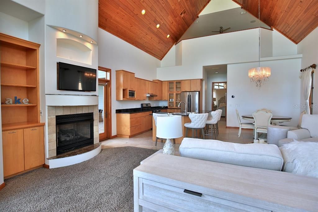 Chandelier, Dining room, Fireplace, Interior, Kitchen, Living room, Pendant Lights, Recessed Lighting, Stainless Steel Appliances, Wooden Ceilings