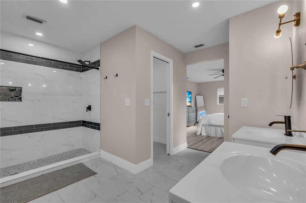 Bathroom, Bedroom, Dual Sink Vanities, Interior, Marble, Marble Walls, Recessed Lighting, Wood Texture Flooring
