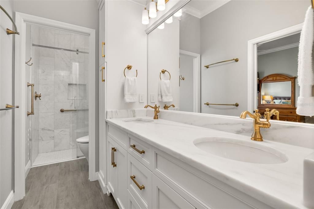 Bathroom, Dual Sink Vanities, Glass Shower, Interior, Marble Walls, Wood Texture Flooring