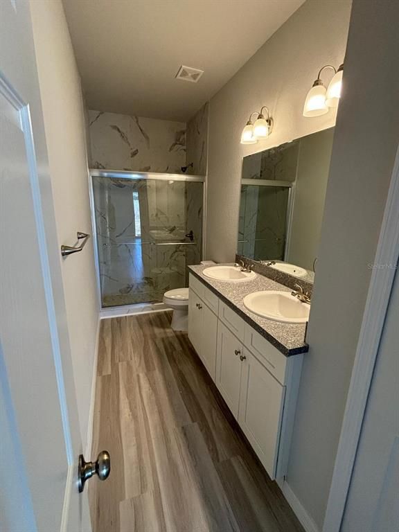 Bathroom, Dual Sink Vanities, Glass Shower, Interior, Marble Walls, Wood Texture Flooring