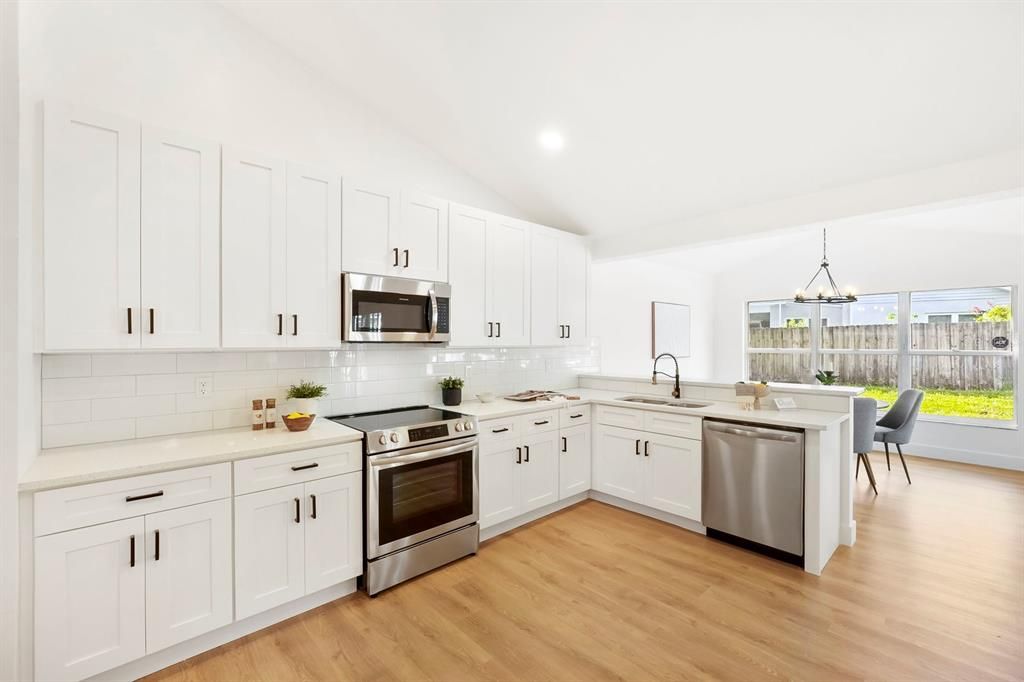 Dining room, Interior, Kitchen, Pendant Lights, Recessed Lighting, Stainless Steel Appliances, Wood Texture Flooring