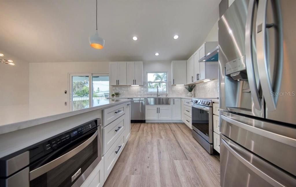 Interior, Kitchen, Pendant Lights, Recessed Lighting, Stainless Steel Appliances, Wood Texture Flooring