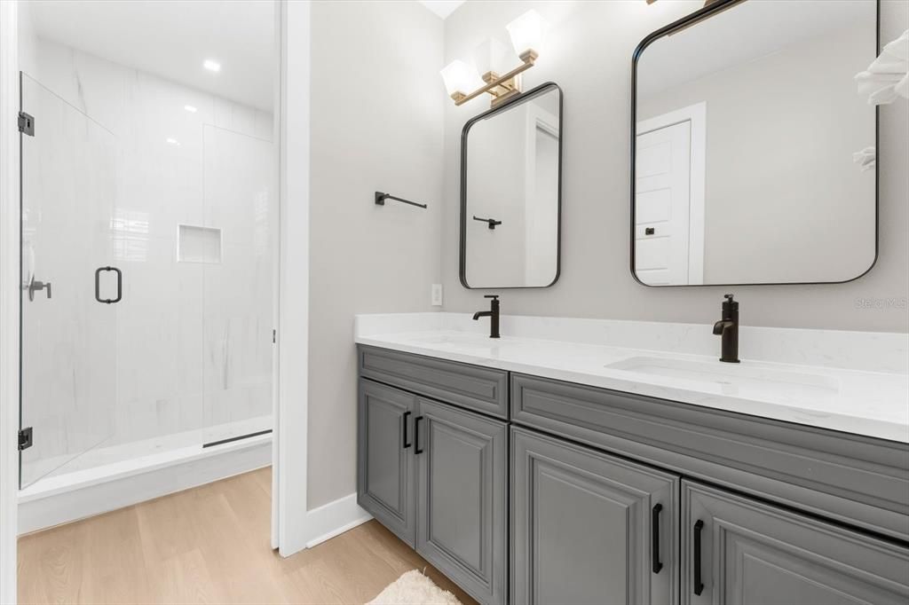 Bathroom, Dual Sink Vanities, Glass Shower, Interior, Recessed Lighting, Wood Texture Flooring