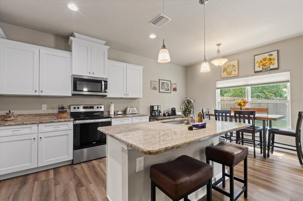 Dining room, Interior, Kitchen, Pendant Lights, Recessed Lighting, Stainless Steel Appliances, Wood Texture Flooring
